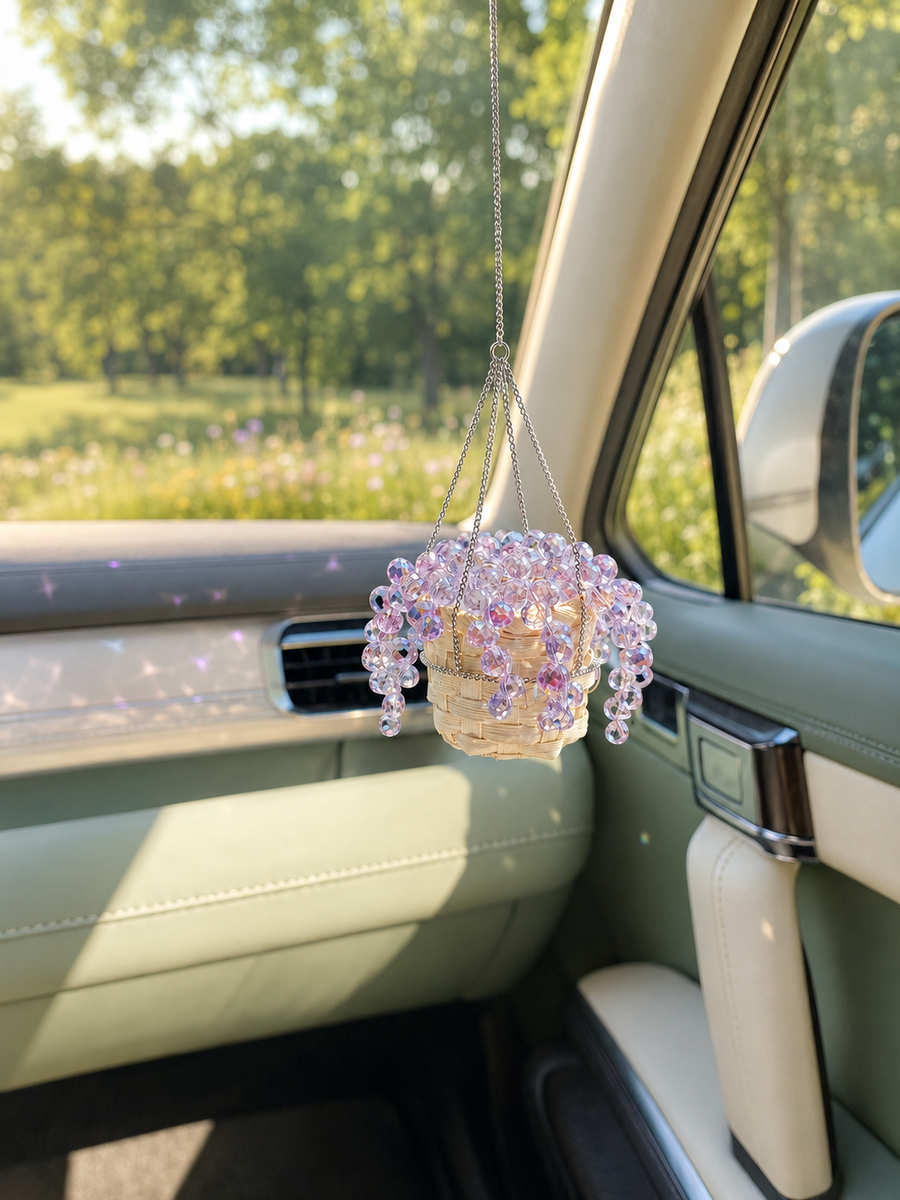 Purple beaded plant car charm sparkling in sunlight