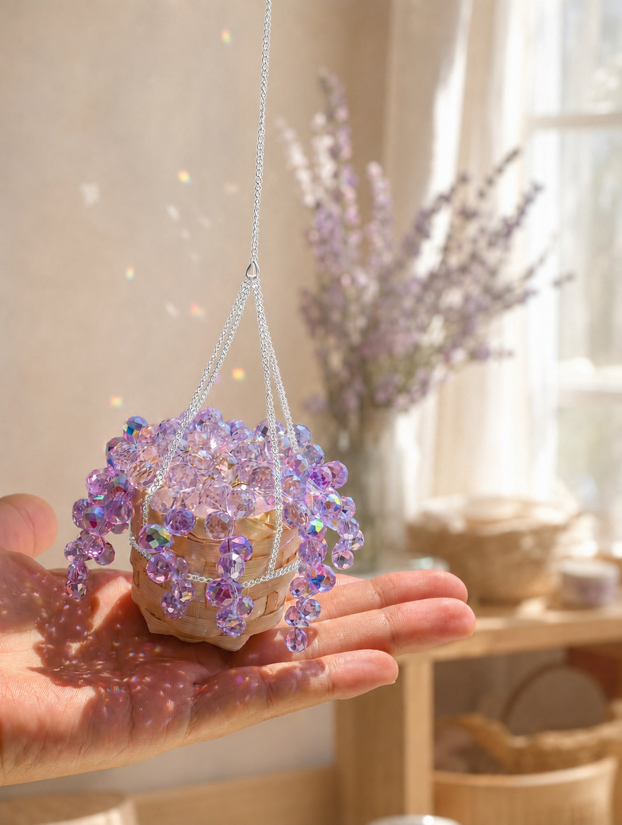 Hand holding mini purple beaded plant with bright silver chain