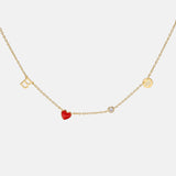Gold necklace with red heart pendant and Tencoo branding on a white background