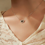 Necklace with a pendant worn by a person in a lace garment