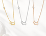  dog-shaped necklaces in gold, silver, and rose gold