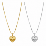 Gold and silver heart-shaped pendants on chains against a white background