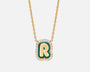 Gold necklace with a green and gold letter 'R' pendant on a white background