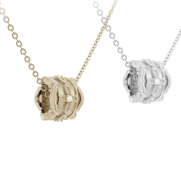 Two gold and silver necklaces with intricate pendants on a white background