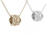 Two gold and silver necklaces with intricate pendants on a white background