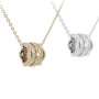 Two gold and silver necklaces with intricate pendants on a white background