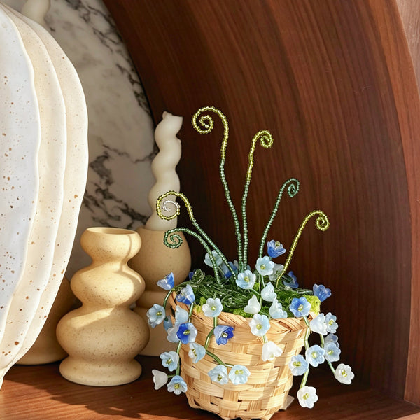 Blue and white beaded flowers in woven basket