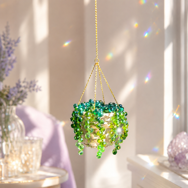 Green crystal beaded hanging plant sparkling by a sunny window